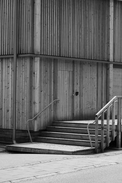 Stairs near wooden wall. 
Black and white photo of stairs 