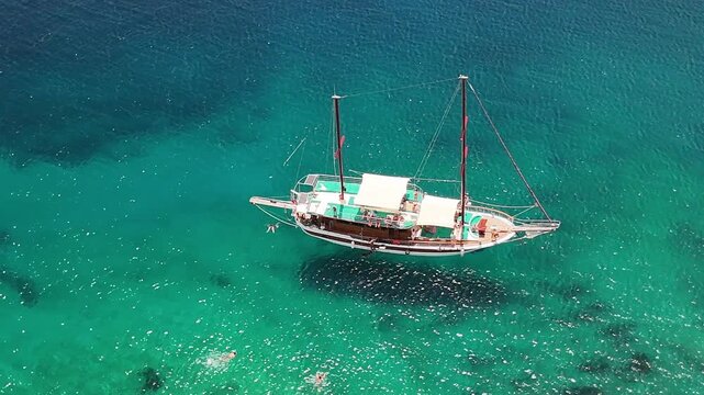 Traditional Turkish gulet anchored in crystal clear turquoise bay near Bodrum Turkey