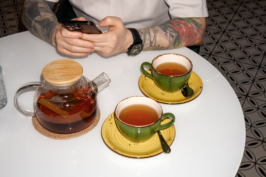 Anonymous Person Working Remotely With Smartphone at Cozy Cafe