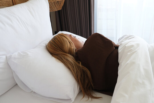 Woman sleeping peacefully in a hotel bed