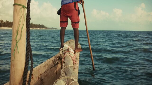Sailor Standing On Wooden Wooden Boat Bow Navigating  Tropical Coast. Fishing Vessel. Sea Journey 