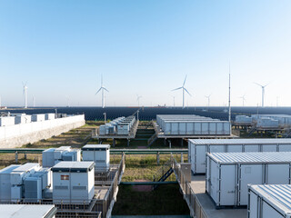 wind turbines and solar battery storage containers in renewable energy facility © zhu difeng