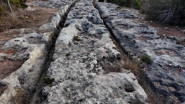 Ancient Cart Ruts on Xemxija heritage trail, parallel cartways groves cut into bare rock.