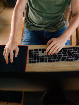 Person Using Keyboard and Mouse at Desk During Daytime