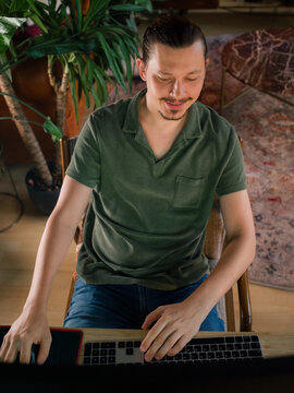 Happy man working at cozy home 