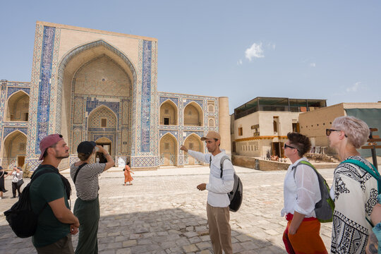 Uzbek Guide Talks to Group in Historical Site in Uzbekistan