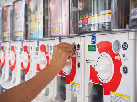 Person Uses a Coin to Operate a Vending Machine