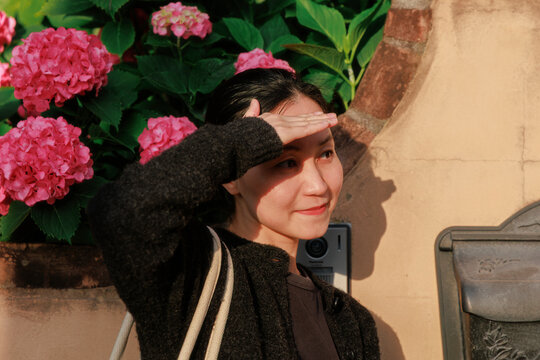 Woman by a Flower Wall During Golden Hour.