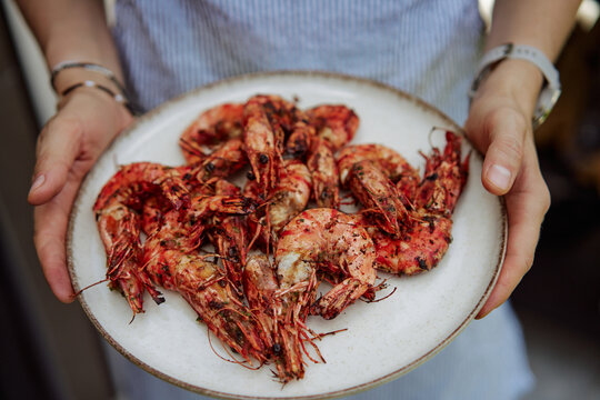 Grilled Shrimp On A Charcoal Grill Being Turned With Tongs At Outdoor 