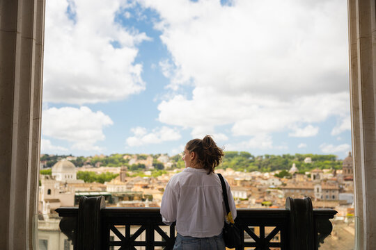 Woman looking at Rome cityscape from the Vittoriano terrace