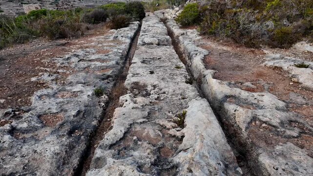 Ancient Cart Ruts on Xemxija heritage trail, parallel cartways groves cut into bare rock.