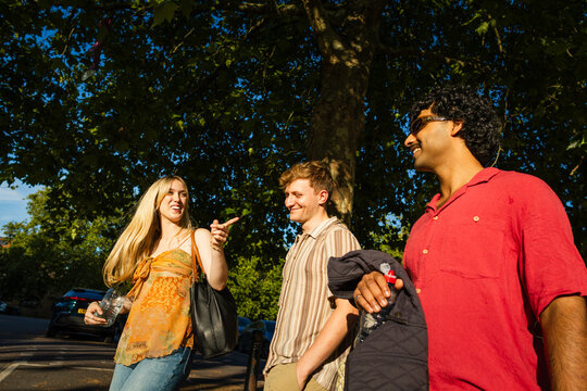Group of young friends walking and talking outdoors