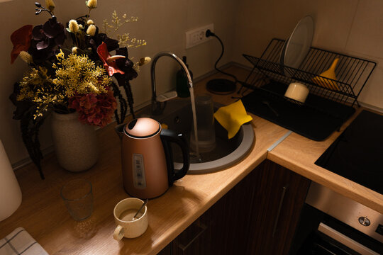 Coffee Cup Beside Kitchen Sink and Flowers