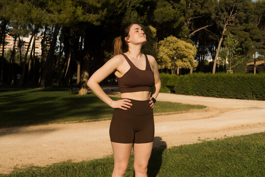 Woman enjoys outdoor workout in park on sunny day