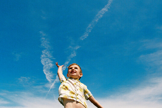 Film portrait of happy boy and big blue sky