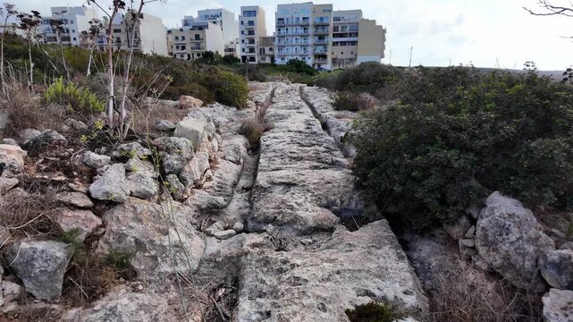 Ancient Cart Ruts on Xemxija heritage trail, parallel cartways groves cut into bare rock.