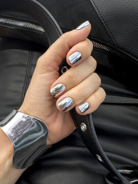 Silver mirror chrome shiny nails and bracelet closeup