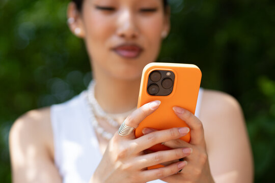 Close up of an Asian Woman Using a Mobile Phone