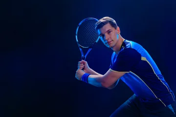 Tennis player hitting fast ball with racket demonstrating strength balance and perfect timing during game practice © Mike Orlov