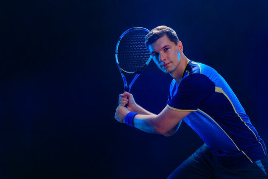 Tennis player hitting fast ball with racket demonstrating strength balance and perfect timing during game practice