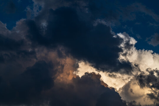 Cloudscape with dark and dramatic clouds at sunset in summer