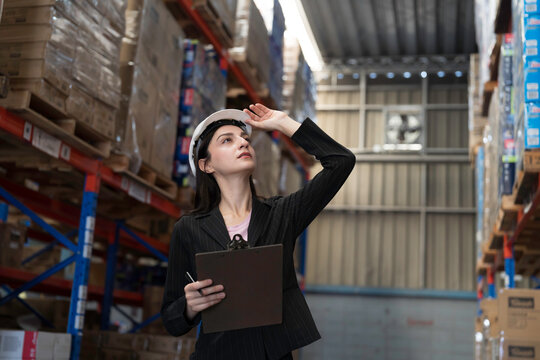 Warehouse, deposit or store. Warehouse worker checking incoming items, reporting broken or missing goods in warehouse