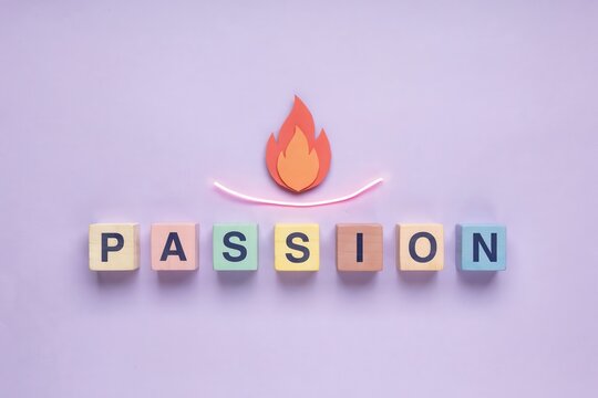 The word passion spelled out with lettered cubes, illuminated by a stylized flame icon, symbolizing inner fire and enthusiasm