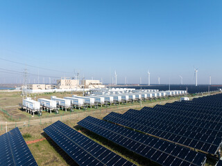 solar panels and energy storage station under blue sky © zhu difeng