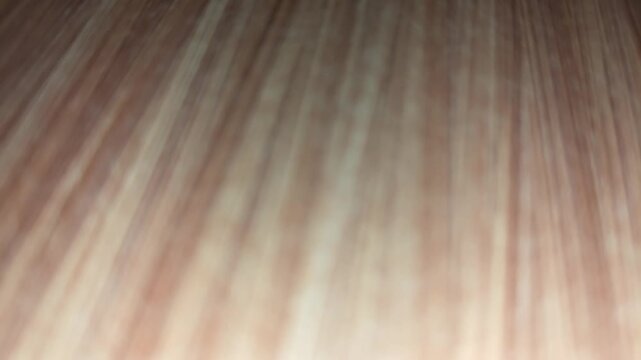 Blurry natural light brown wood grain texture background with diagonal soft striped pattern for abstract design overlay