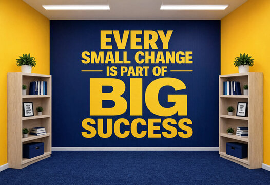 Inspirational wall art with yellow text about big success and small changes in a modern office setting