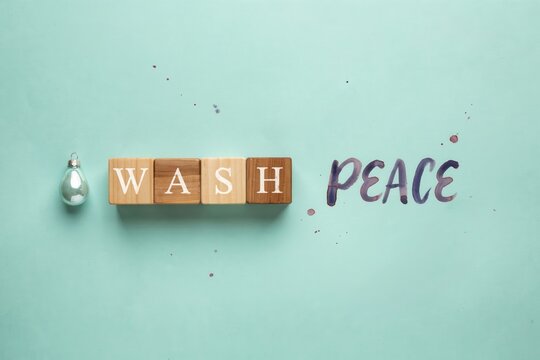 Wash Peace text message made of wooden blocks and painted letters on pastel green background