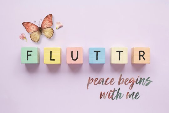 Fluttering butterfly over colorful alphabet blocks spelling 'FLUTTR' with the inspirational phrase 'peace begins with me' elegantly written below
