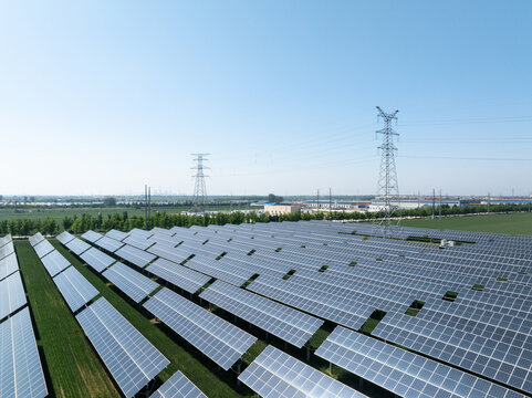 neatly arranged solar photovoltaic panels under blue sky