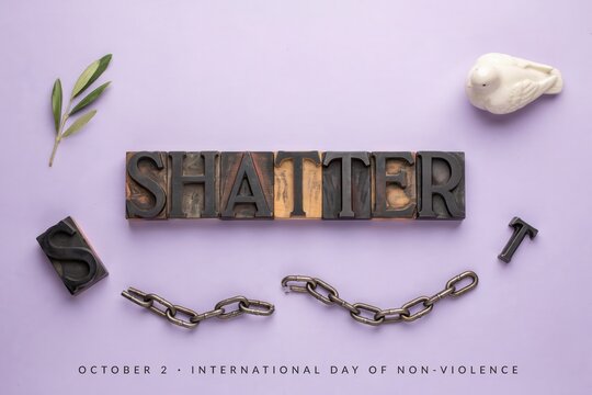 International Day of Non-Violence banner concept with broken chain, white dove, olive branch, and shatter word on purple background