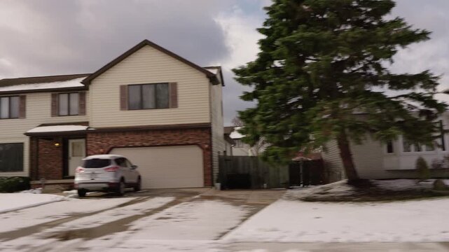 Snow-Covered American Suburban Houses Seen from a Moving Vehicle