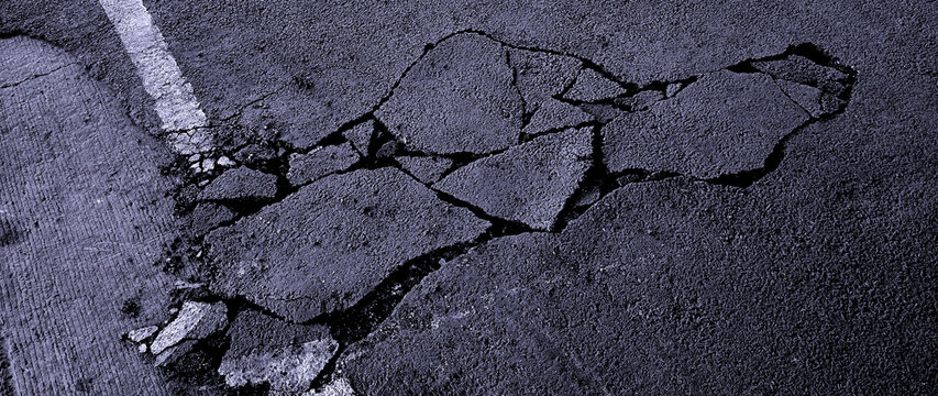 Cracked asphalt pavement with white road line. Damaged and cracked dark asphalt road background, Pavement cracks, Damaged road surface. not ai