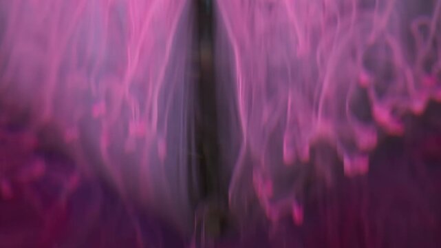 Paint liquid. Fume flow. Defocused pink neon purple colorful water drip vapor spreading on abstract dark black creative background.