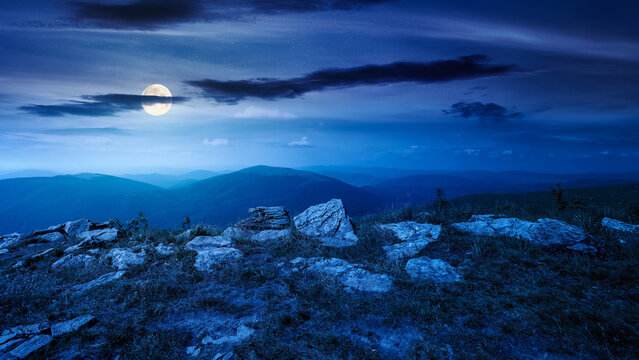 Carpathian mountain landscape in summer at night. scenic view of Transcarpathia region from the mnt. Smooth. alpine blueberry field with rock on the Polonyna Runa hill in full moon light