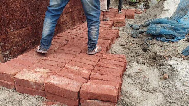 Manual Brick Laying and Construction Work in Progress Outdoors