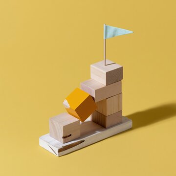 Rising wooden block staircase with a blue flag on a yellow background, showcasing a textured and sunlit path for goal achievement and growth