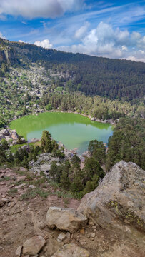 Aerial view of Laguna Negra de Urbion surrounded by pines
