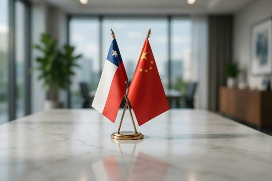 Small desk flags of chile and china crossed on a white marble table in a blurred office meeting room for international diplomacy concepts