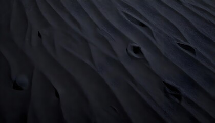 Obraz premium Close-up high-angle shot captures the texture of dark sand dunes