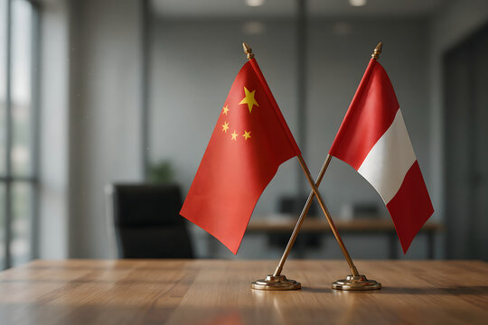 Small desk flags of china and peru crossed on a wooden table in a blurred office meeting space for international diplomacy and relations