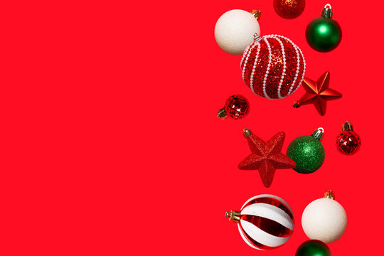 Festive Christmas background with red, green and white ornaments arranged vertically on the right and large copy space. Ideal for cards, banners, social media and holiday advertising.