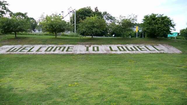 Ground Level View of Welcome to Lowell Landscape Sign in Lowell Massachusetts
