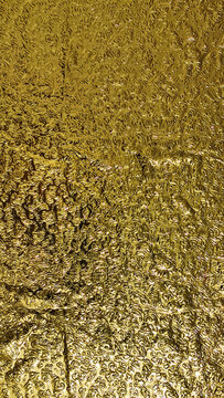Golden metallic gold foil textured glowing luxury background