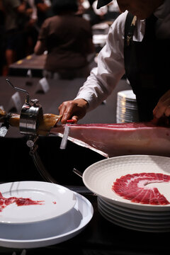 experto cortador de jam&oacute;n, cortando lonchas de jam&oacute;n ib&eacute;rico de una paleta de jam&oacute;n