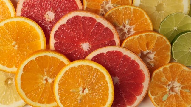 Sliced citrus fruits assortment moving slowly
