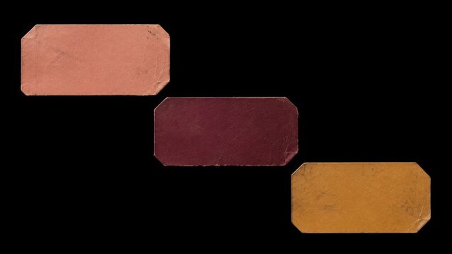 Three worn blank paper labels isolated on black background